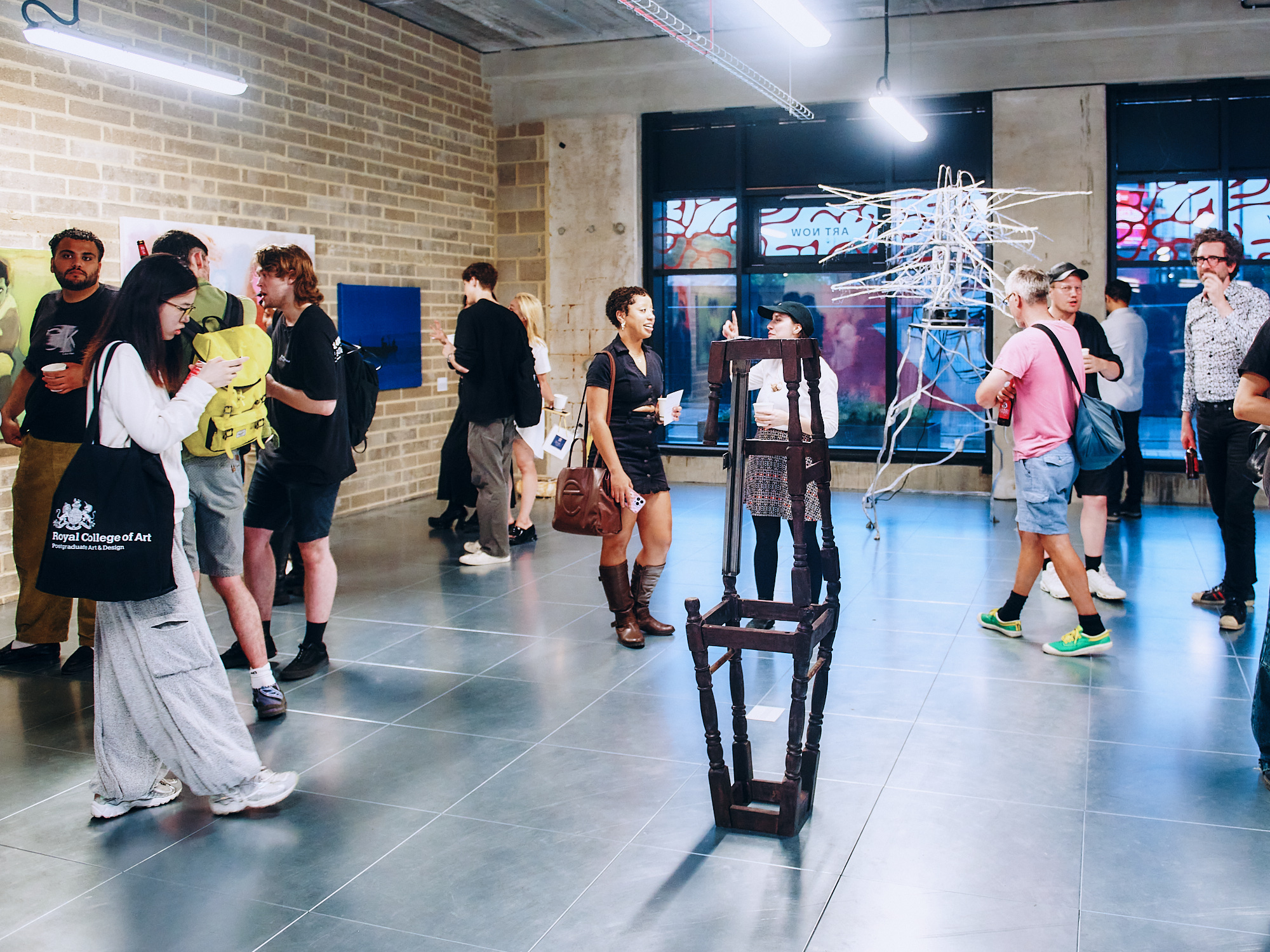 people standing inside a gallery studio