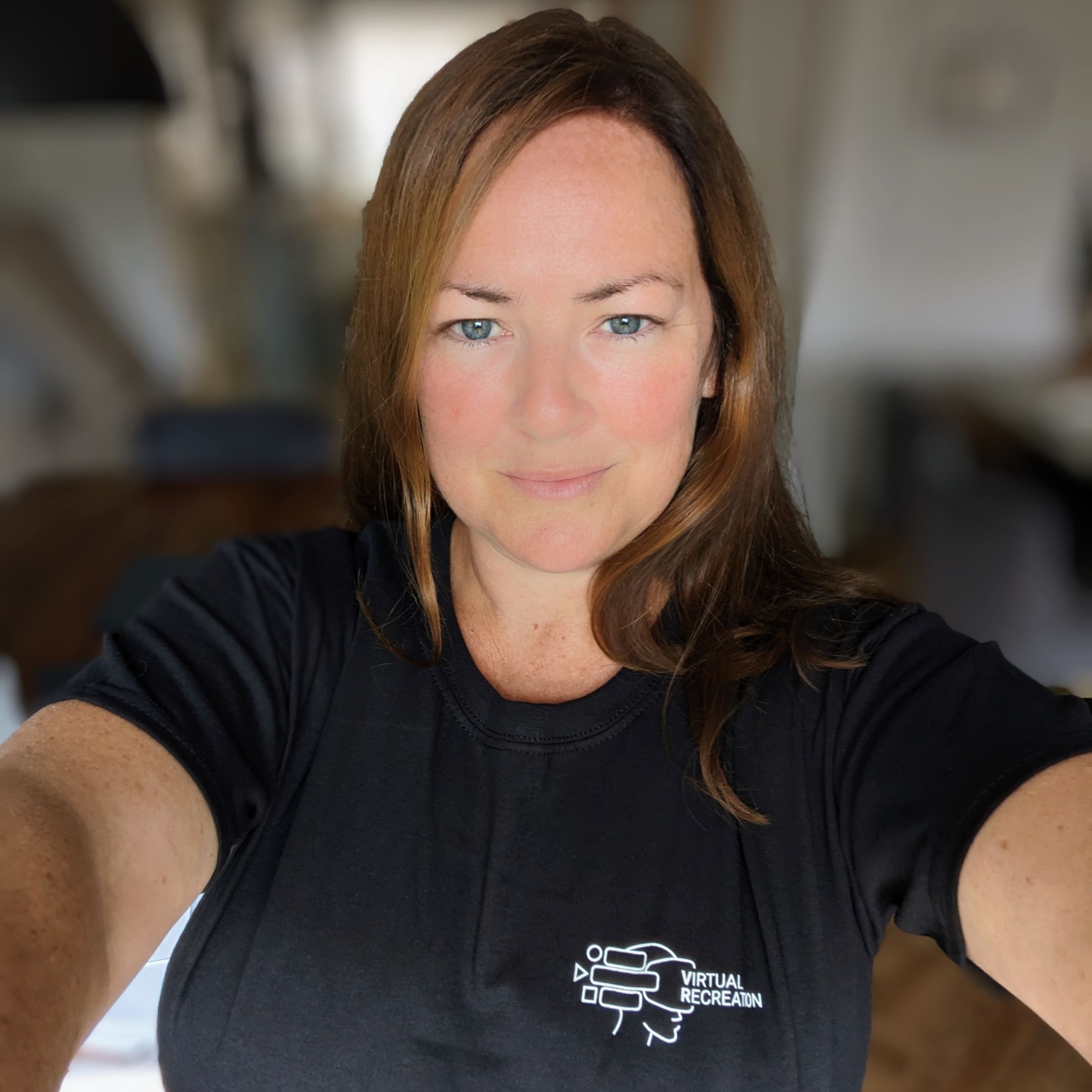 Portrait photo of Jackie. She is wearing a blavk t-shirt and has brown hair